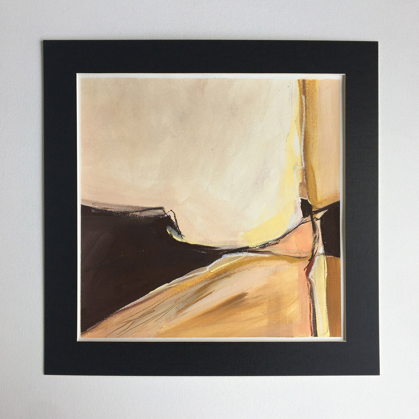 One-of-a-kind mixed media artwork in warm gray, brown, white, light ochre, raw sienna, and black colors. Intuitive landscape composition in the artist's art practice. Framed in black, matt paper frame.