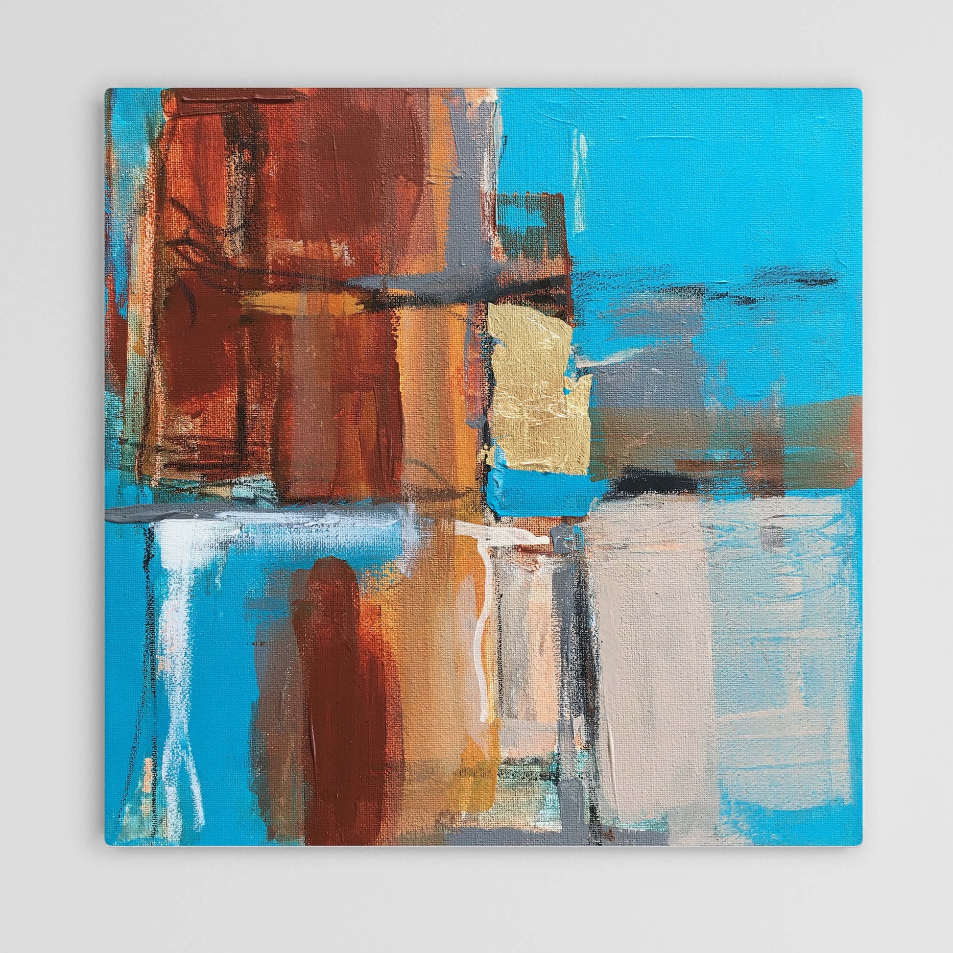 Abstract painting in burnt sienna, light blue, white colors, and gold foil. The artwork is made with acrylic colors and mixed media.