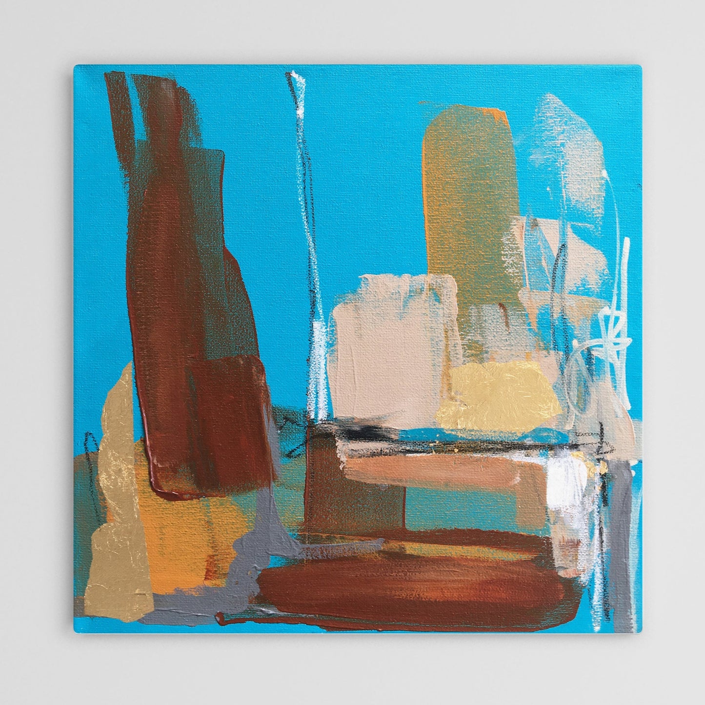 Abstract painting in burnt sienna, light blue, white colors, and gold foil. The artwork is made with acrylic colors and mixed media.