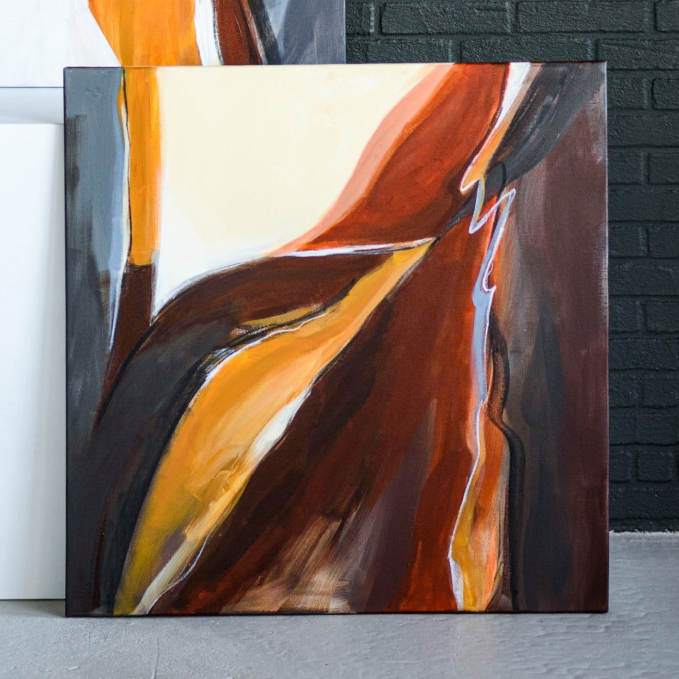 One-of-a-kind abstract artwork. 90x90cm 35.43"x35.43" Acrylic | Mixed Media on canvas. Raw sienna, burnt sienna, ochre, umbra, black, and white colors. Stretched canvas. Ready to hang. Unframed. Contemporary artwork for modern interiors. The artist's personal story about wind inspires contemporary abstract artwork in the room