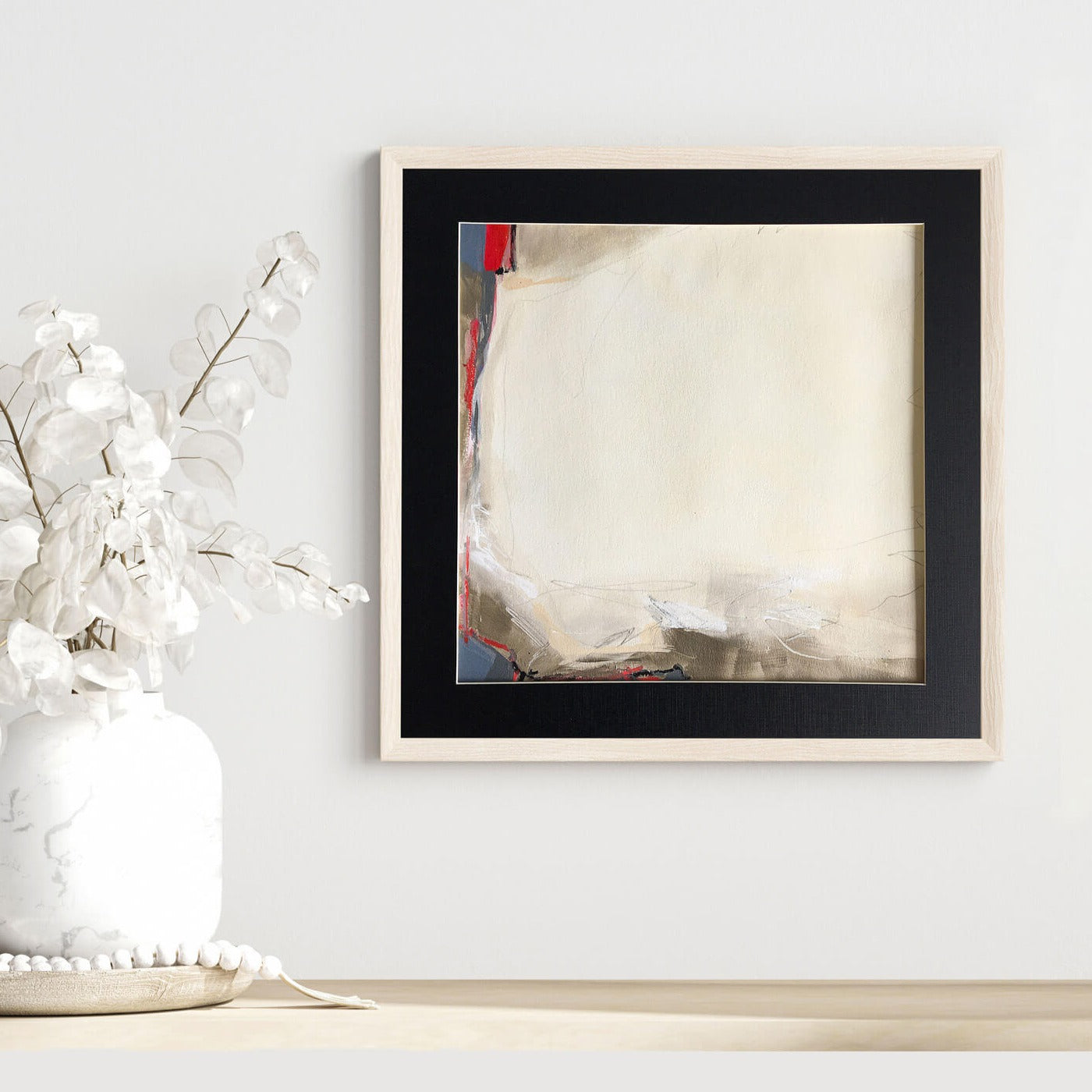 One-of-a-kind mixed media artwork THE SILENCE OF THE HOLIDAY LANDSCAPE on paper in white, red, and black colors. Intuitive and dynamic composition in the artist's art practice. Framed in black, matt paper frame. Mockup by vnmockup